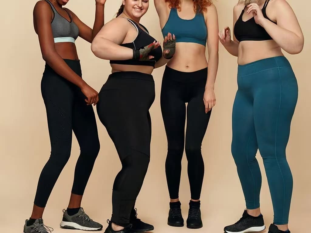 Plus size model wearing high-support leggings made by specialized plus size activewear manufacturers offering inclusive sizing blocks.