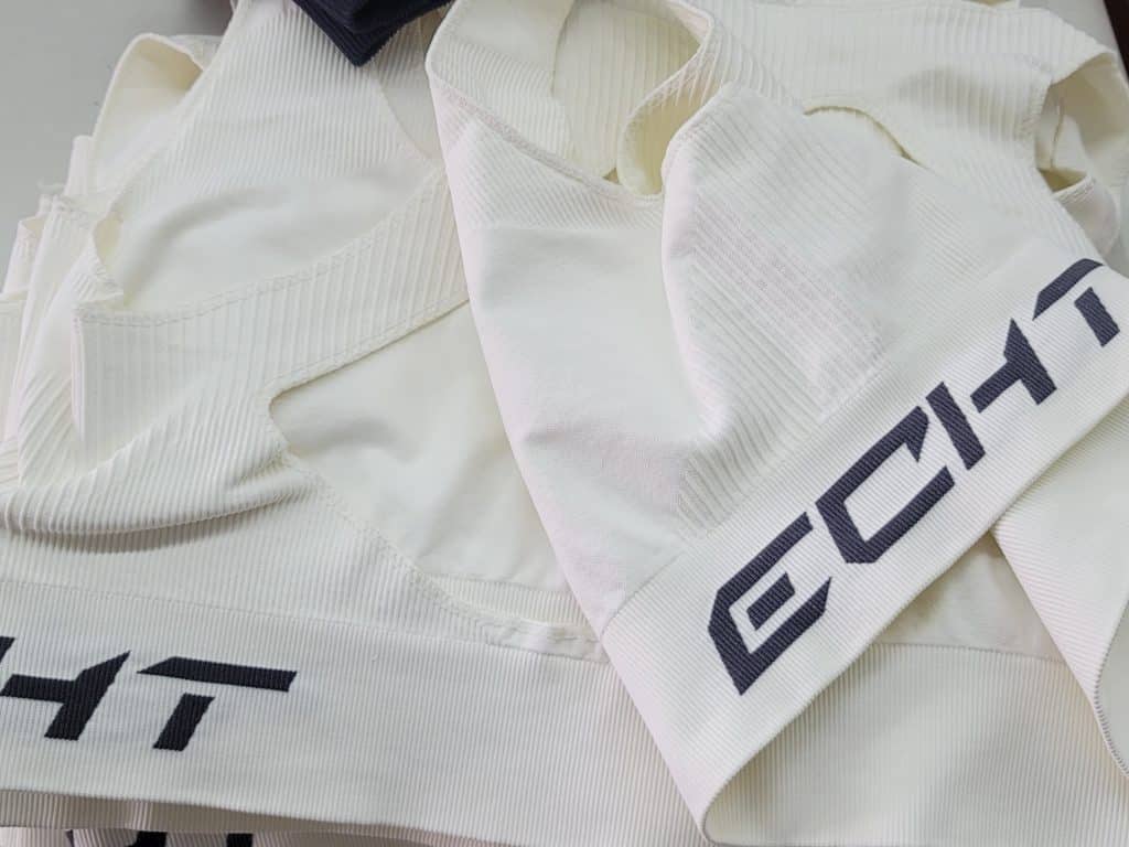 Seamless activewear fabric detail typically produced by an ECHT manufacturer showing custom logo jacquard structure.